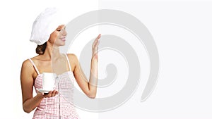 Chef woman with cup showing indicate white billboard, coffee, tea, chocolate marketing concept