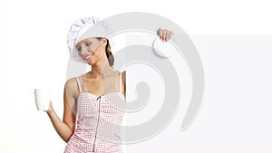 Chef woman with cup showing indicate white billboard, coffee, tea, chocolate marketing concept