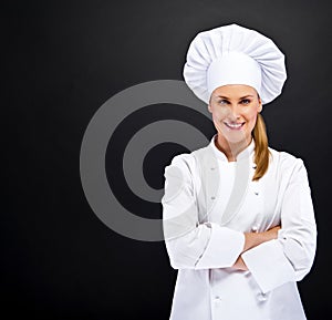 Chef woman over dark bacground standing