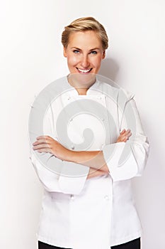 Chef woman over white background with crosed arms smiling.