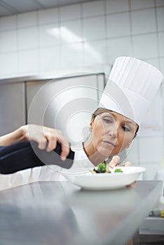 Chef, woman and plate in kitchen for catering service, fine dining or prepare dish. Hospitality, professional and female