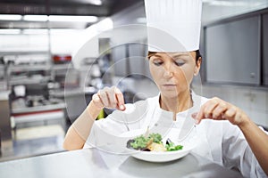 Chef, woman and plate in kitchen for fine dining, catering service or prepare dish. Hospitality, presentation and hands