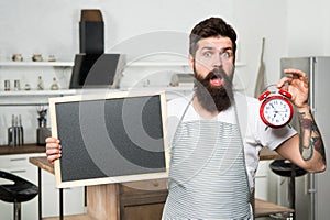 Chef at work. dinner menu from skilled chef. surprised bearded man in cook apron. lunch time. Time alarm on diet and