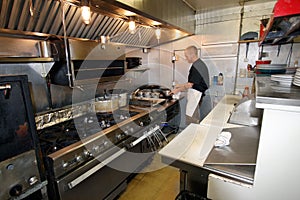 Chef at work in small kitchen