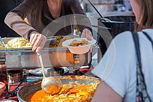 Cheff cooking delicious chicken soup dish outdoor.