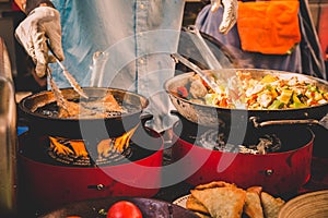 Cheff cooking fusion international cusine on street stall on international street food festival of Odprta kuhna, Open