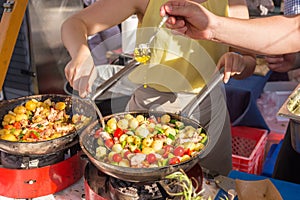 Cheff cooking traditional Mediterranean octopus on street stall.