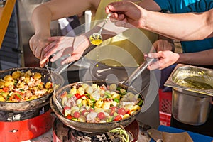 Cheff cooking traditional Mediterranean octopus on street stall.