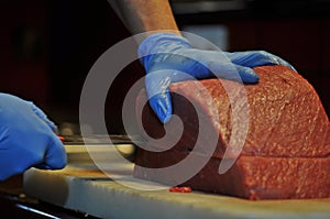 Cheff cutting red tuna in a restaurant