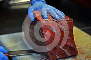 Cheff cutting red tuna in a restaurant