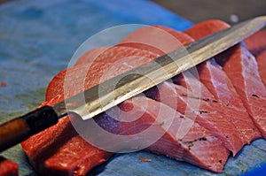 Cheff cutting red tuna in a restaurant