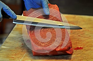 Cheff cutting red tuna in a restaurant