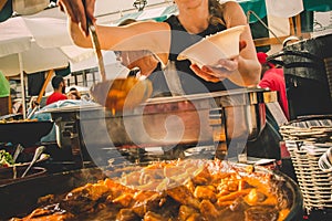 Cheff serving fusion international cusine on street stall on international street food festival of Odprta kuhna, Open
