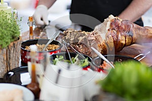 Cheff serving traditional meat dish on street stall on street food festival, Ljubljana, Slovenia.