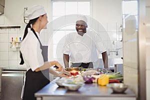 Chefs chopping vegetables in the commercial kitchen