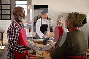 Chefs discussing while cooking