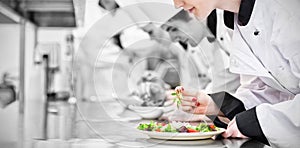 Chefs finishing their salads in culinary class photo