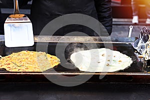 Chefs are fried omelets mixed with vegetables and mushrooms, street food