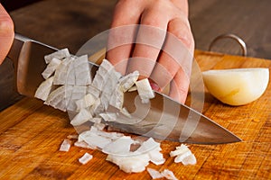 Chefs hands chopping onion