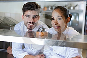 chefs in kitchen looking at camera