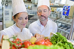 chefs looking at crate vegetables