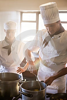 Chefs preparing food at stove