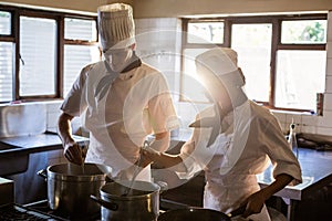 Chefs preparing food at stove