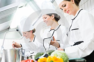 Chefs preparing meals in commercial kitchen