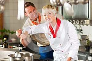 Chefs in a restaurant or hotel kitchen cooking