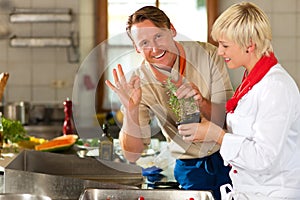 Chefs in a restaurant or hotel kitchen cooking