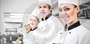 Chefs showing their salads in commercial kitchen