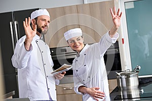 chefs waving hands