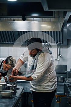 Two chefs working in professional kitchen