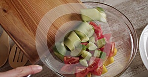 Cheif preparing vegetables for organic salad in modern kitchen