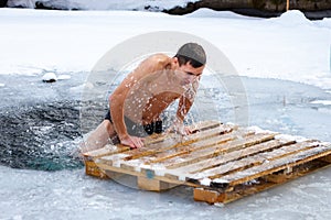 Chelyabinsk Oblast, Russia - Febrary 8, 2015: man a walrus gets out after swimming in the winter in an ice-hole.