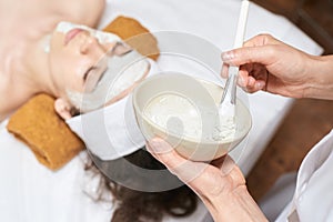 Chemic facial peel mask. Cosmetology acne treatment. Young girl at medical spa salon. Brush. Face fruit acid. Sensitive peeling