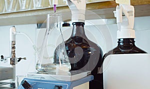 Chemical analysis laboratory. Flask with solution during titrating