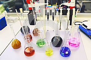 Chemical analysis, pharmacology and laboratory concept. Flasks with colored liquid reagents in a science laboratory