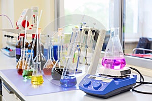 Chemical analysis, pharmacology and laboratory concept. Flasks and scales with colored liquid reagents in a science laboratory