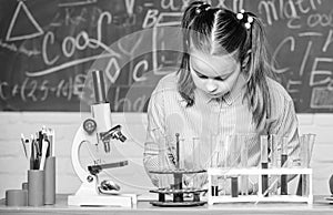Chemical analysis. Test tubes with substances. Laboratory glassware. School laboratory. Girl smart student conduct