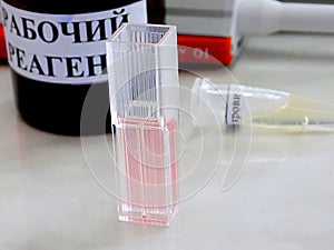 Chemical composition: pink colored solution in the photometry cuvette and other biochemistry utensils
