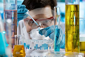 Chemical engineer pipetting samples in tube pcr in the research laboratory