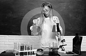 Chemical experiment. Funny schoolgirl kid doing experiments in the laboratory. Explosion in the lab. Science and