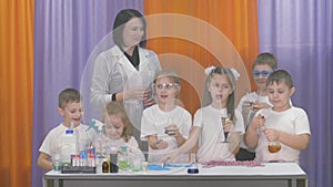 Chemical experiments for children. Fun experiments for children. A woman conducts cognitive science lessons. Room is