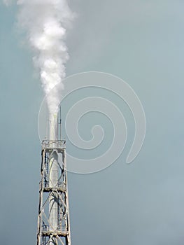 Chemical factory polluting air, tower closeup.