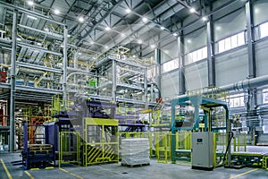 Chemical factory. Thermoplastic production line. Production and packing machinery in large area of industrial hall
