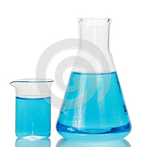 A chemical flask and beaker with blue liquids isolated on white