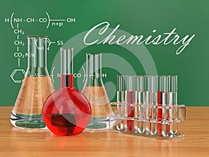Chemical flasks and blackboard with formulas.