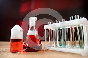 Chemical flasks with colorful liquids on laboratory desk