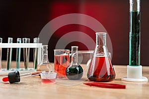 Chemical flasks with colorful liquids on laboratory desk